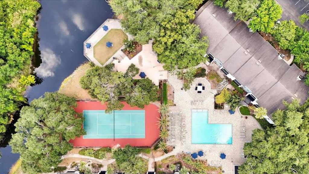 a backyard with a pool and a house and a yard with trees