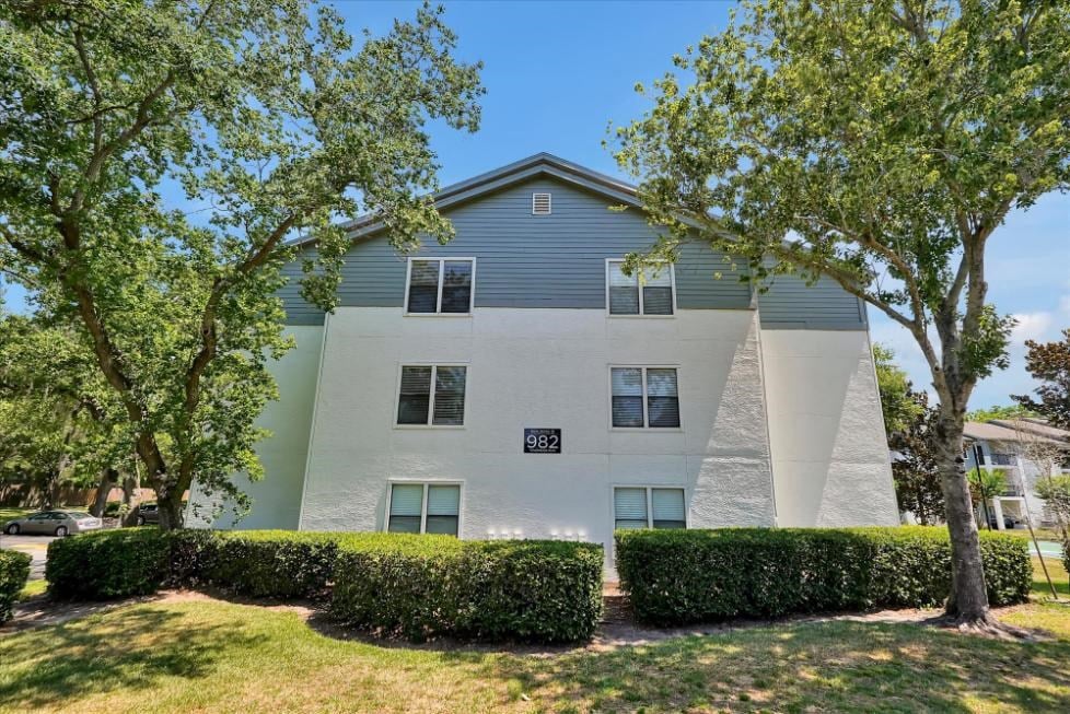 a white building with trees in front of it