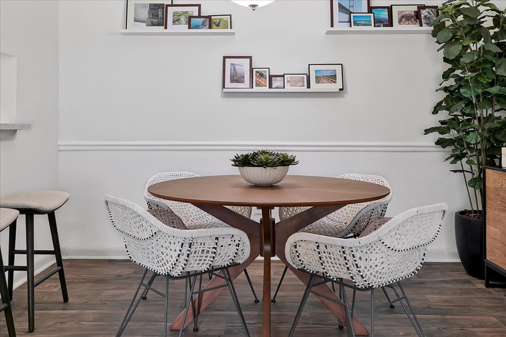 a dining room with a wooden table and white chairs