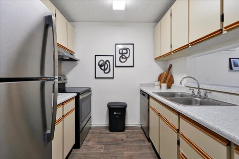 a kitchen with a sink and a refrigerator