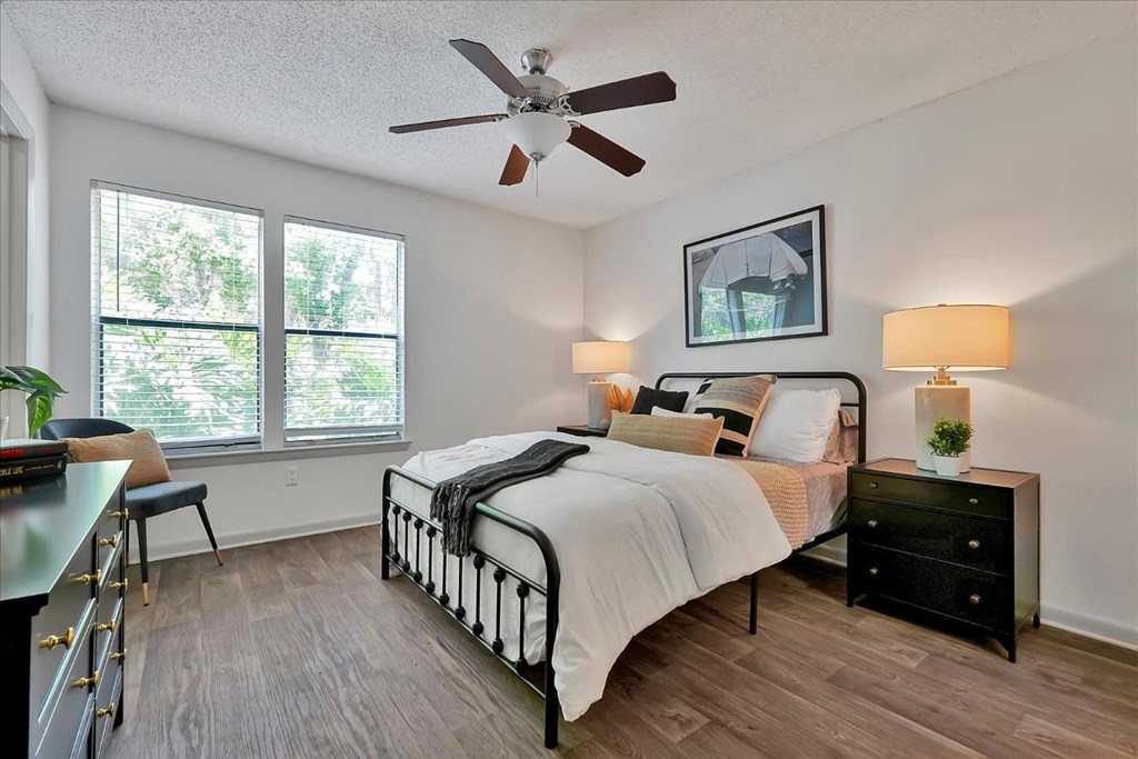 a bedroom with a bed and a ceiling fan