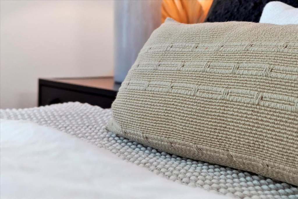 a pillow on a bed in a bedroom