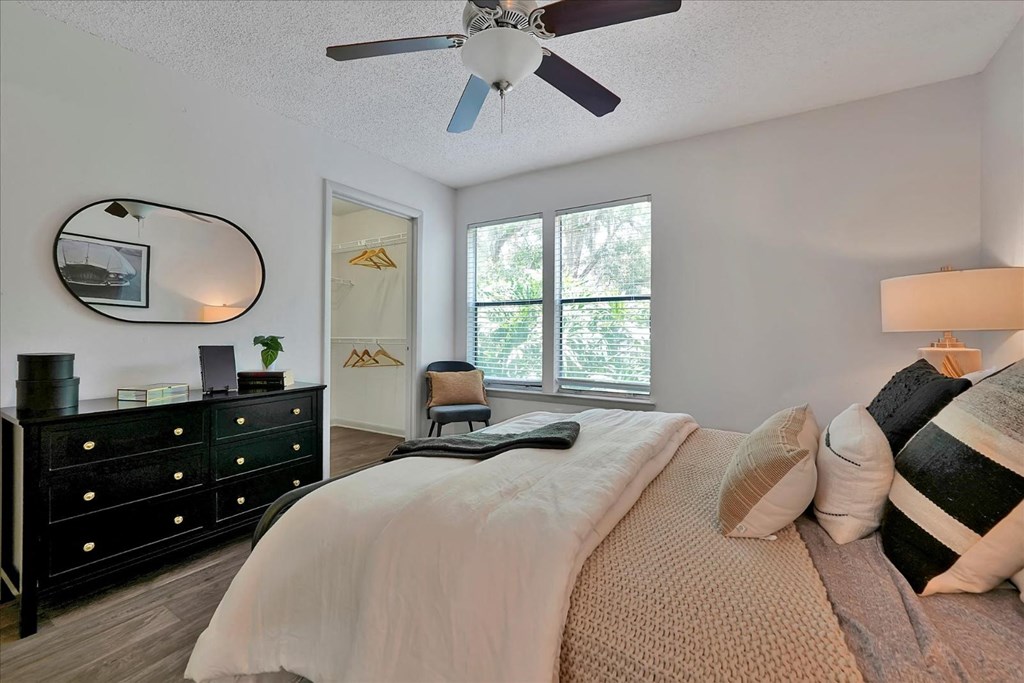 a bedroom with a bed and a ceiling fan