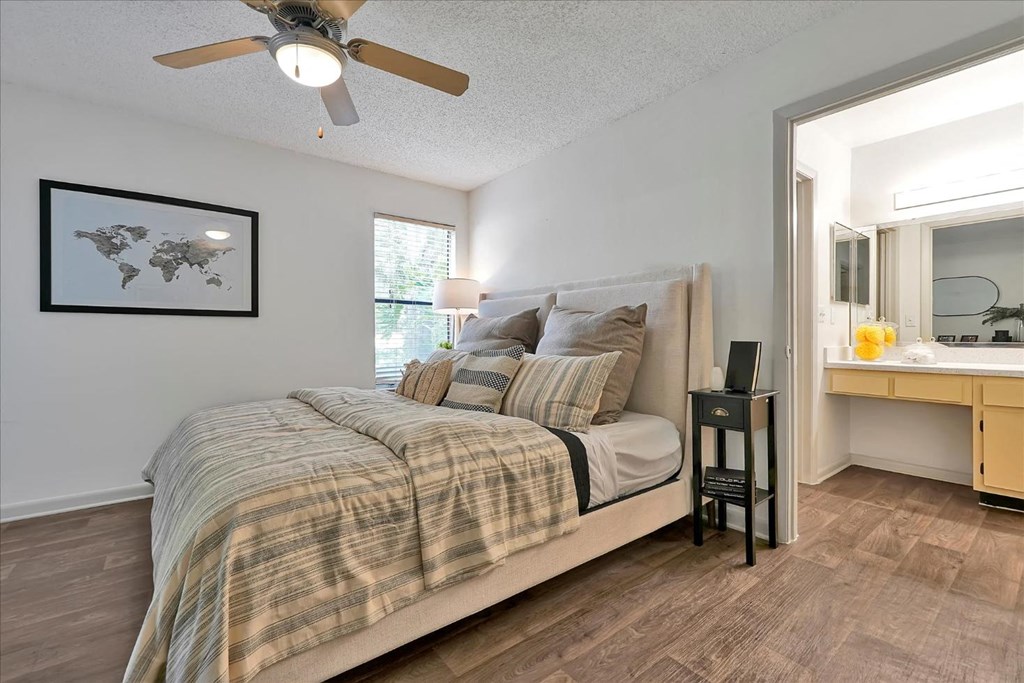a bedroom with a bed and a ceiling fan