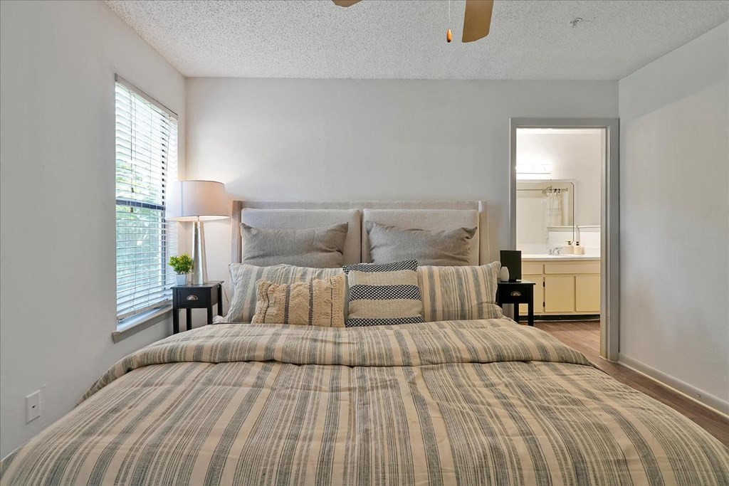 a bedroom with a bed and a mirror