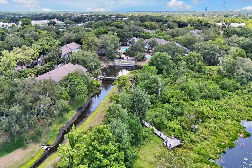 an aerial view of a river and some houses and trees
