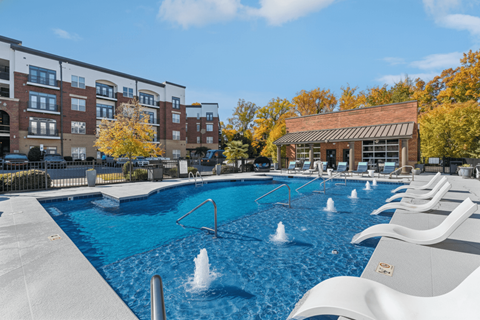 A swimming pool with a fountain in the middle of it.