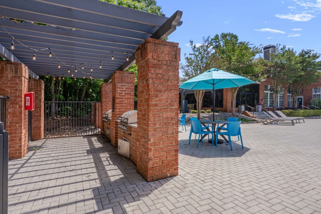 a patio with a table and chairs under awning