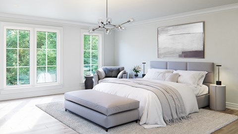 A bedroom with a large bed and a chandelier.