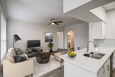 an open living room and kitchen with a white counter top