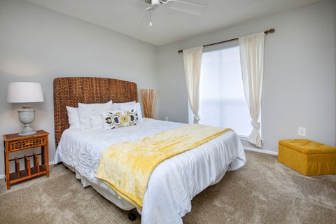 a bedroom with a bed and a window