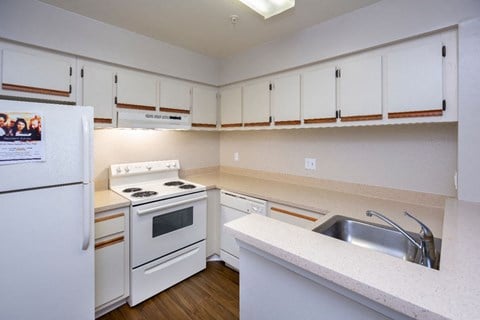 a kitchen with white appliances and white cabinets