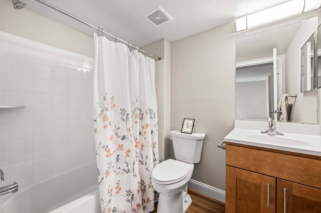 A white toilet sits next to a white sink in a bathroom.