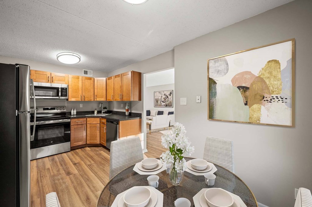 A modern kitchen with a dining table set for four.