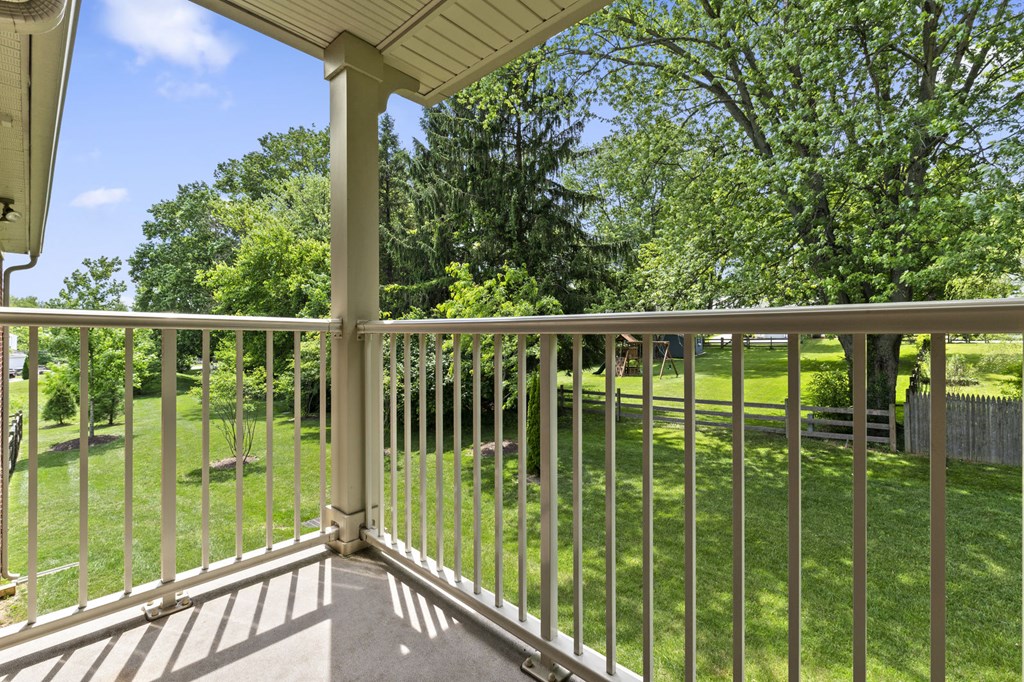 a view of the yard from the balcony of an apartment