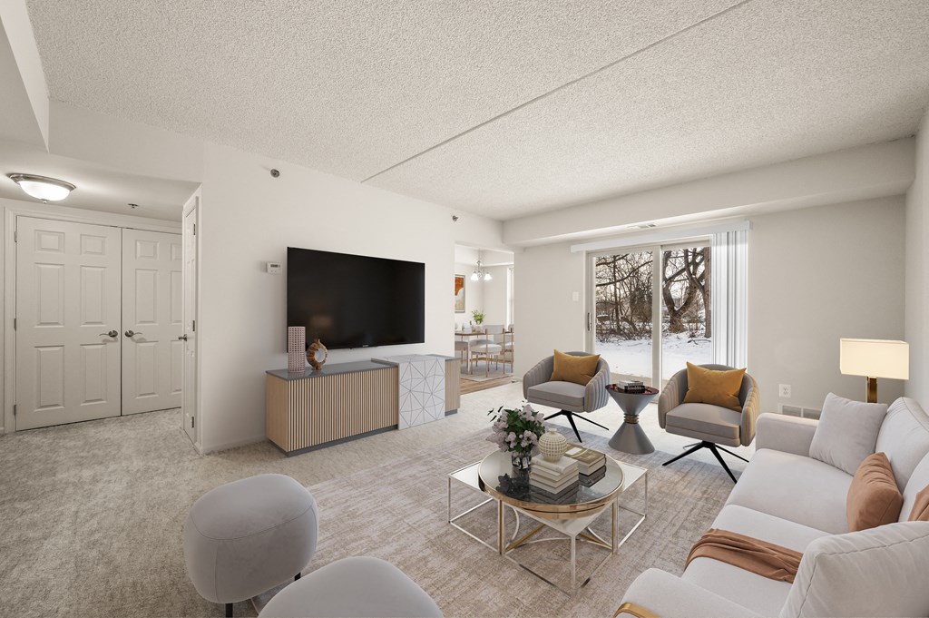 A living room with a television, two chairs, a sofa, and a coffee table.