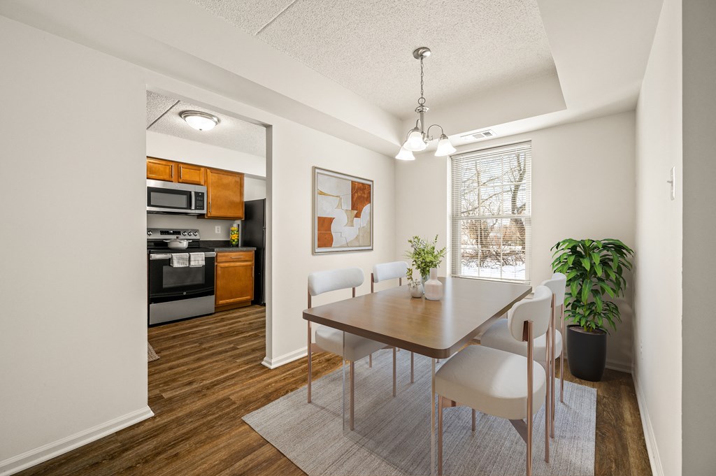A modern kitchen with a dining table and chairs.