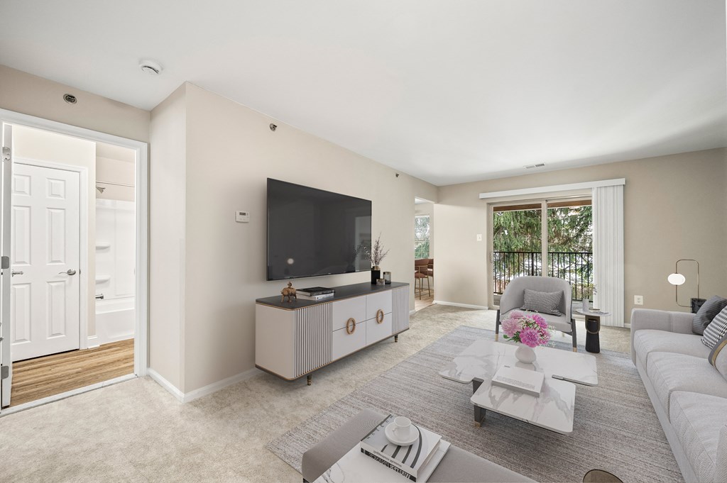 A modern living room with a television, sofas, and a coffee table.