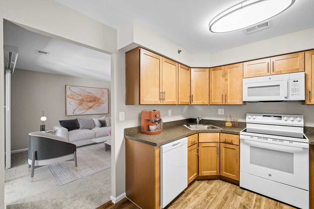 A kitchen with wooden cabinets and white appliances.