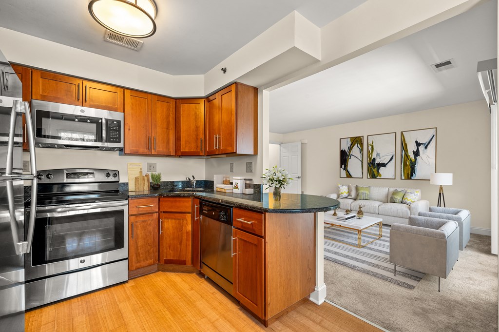 A modern kitchen with wooden cabinets and stainless steel appliances.
