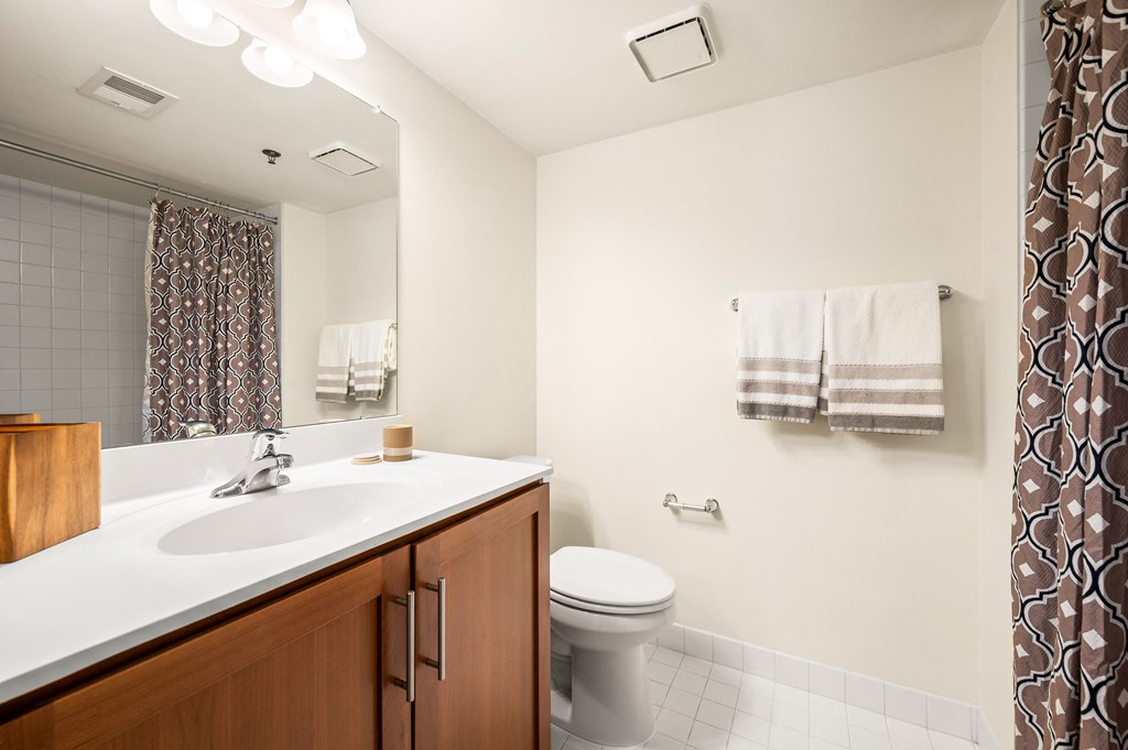 A bathroom with a white sink and a white toilet.