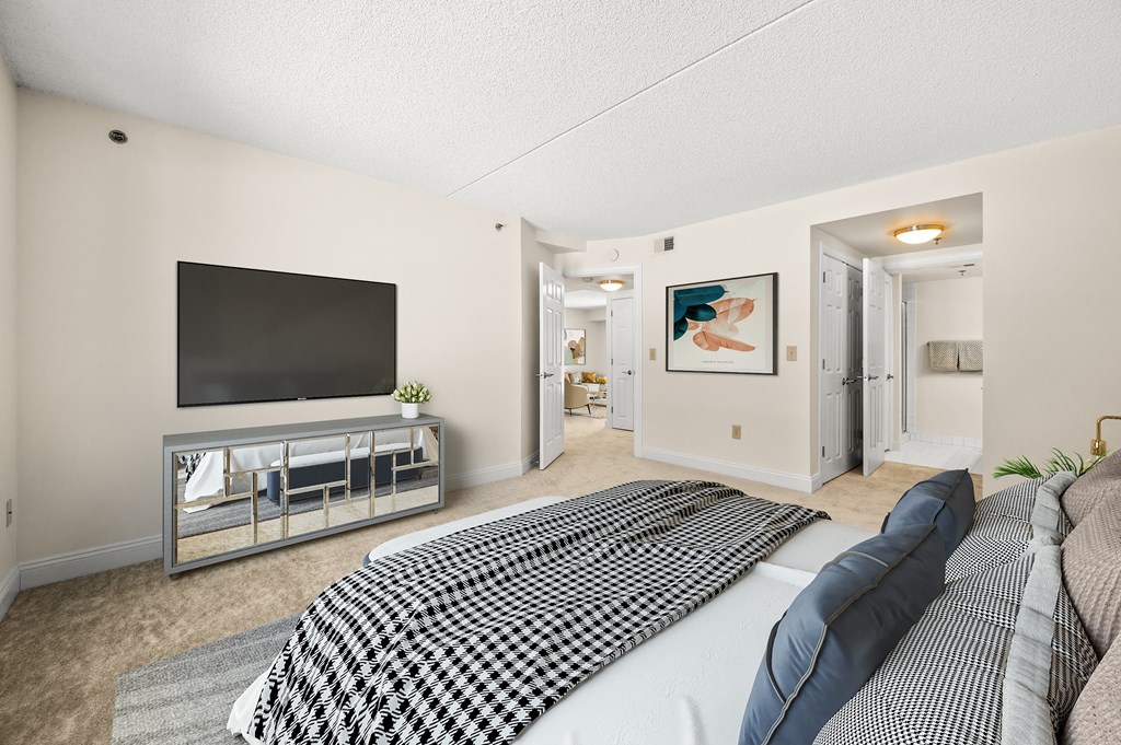 A bedroom with a large bed and a television.