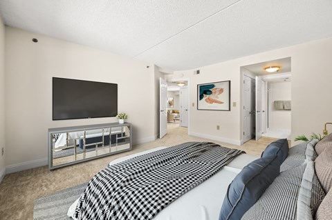 A bedroom with a large bed and a television.