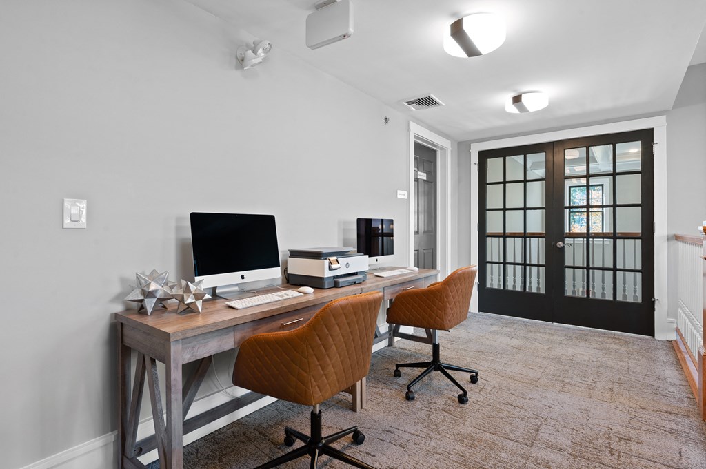 iMac computers available in the coworking space at Claremont Apartments in Exton, PA, providing convenience for residents