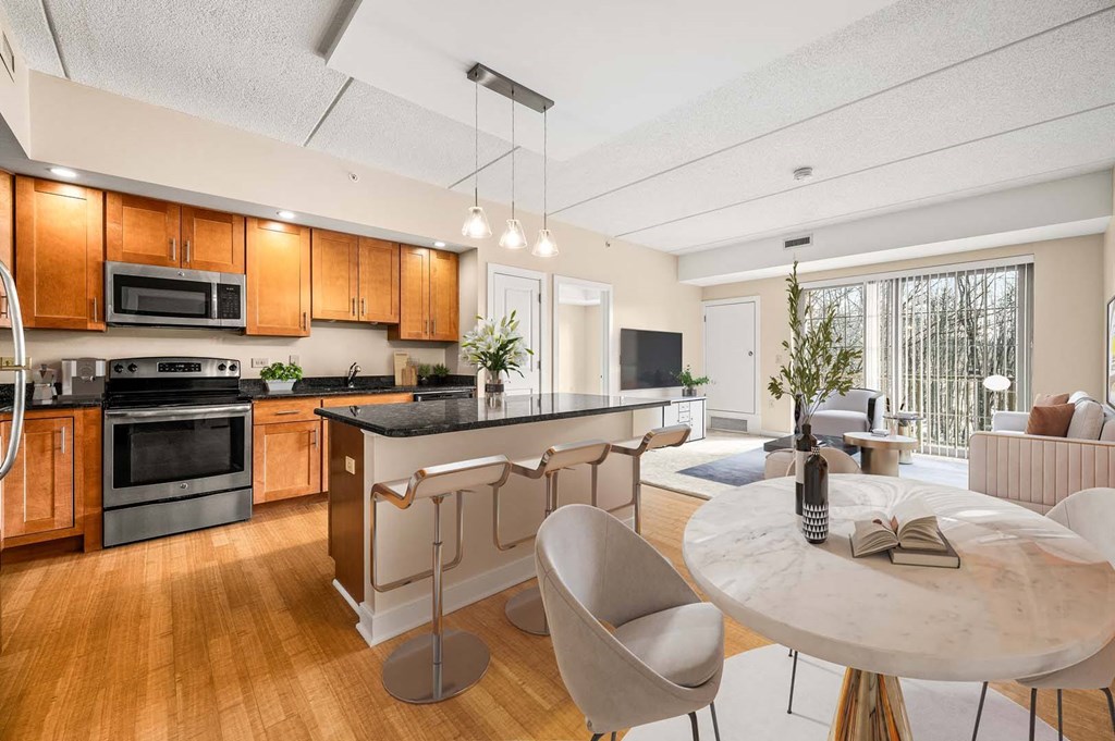 A modern kitchen with wooden cabinets and a black countertop.