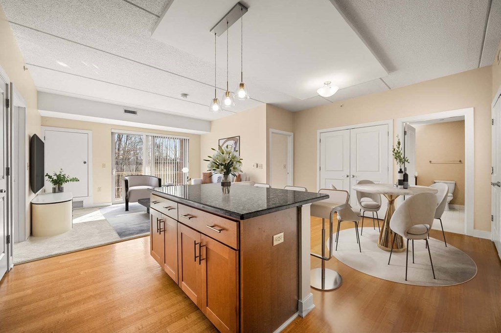 A kitchen with wooden cabinets and a black countertop.