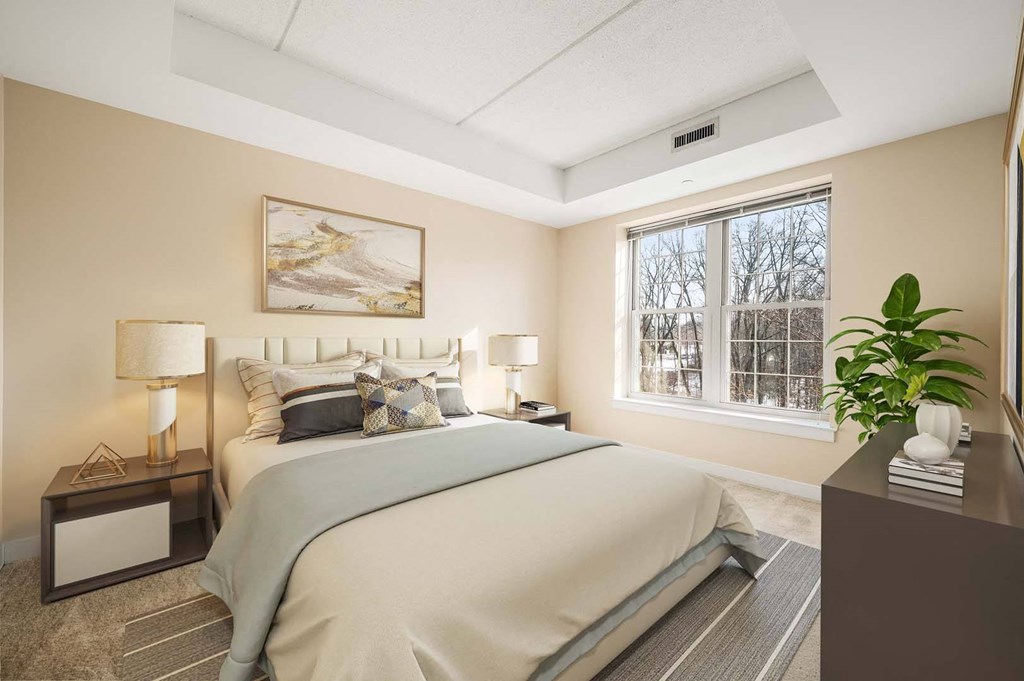 A bedroom with a large bed and a painting on the wall.