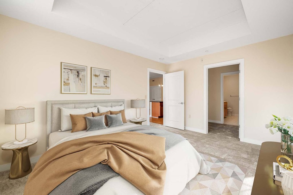 A bedroom with a large bed and a brown blanket.