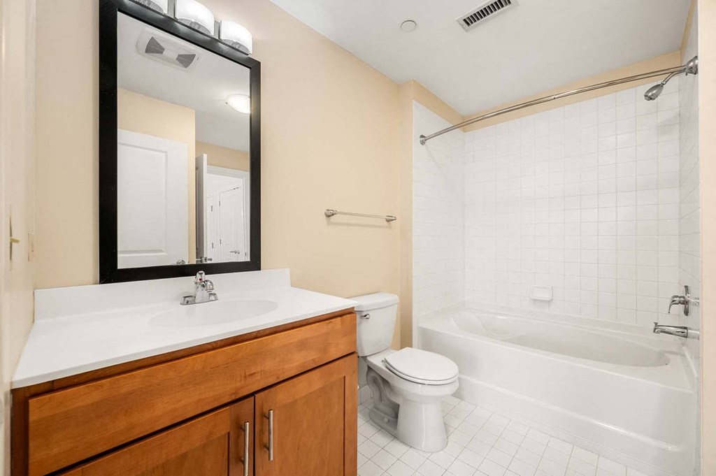 A bathroom with a white sink, toilet, and bathtub.