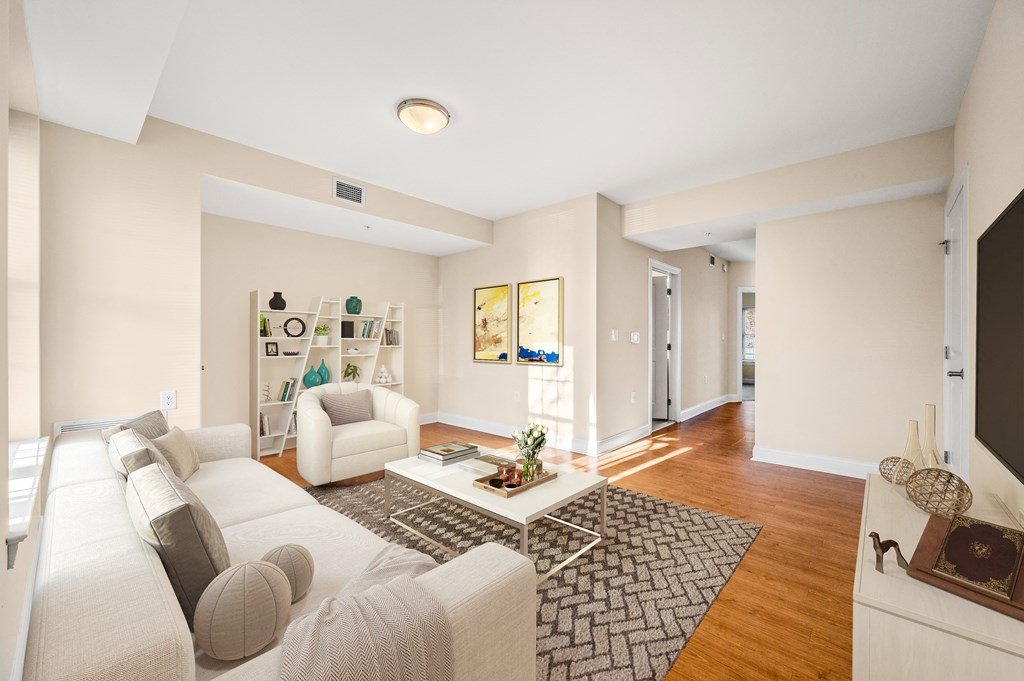 A living room with a white couch and a coffee table.