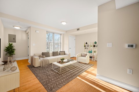 A living room with a white couch and a coffee table.