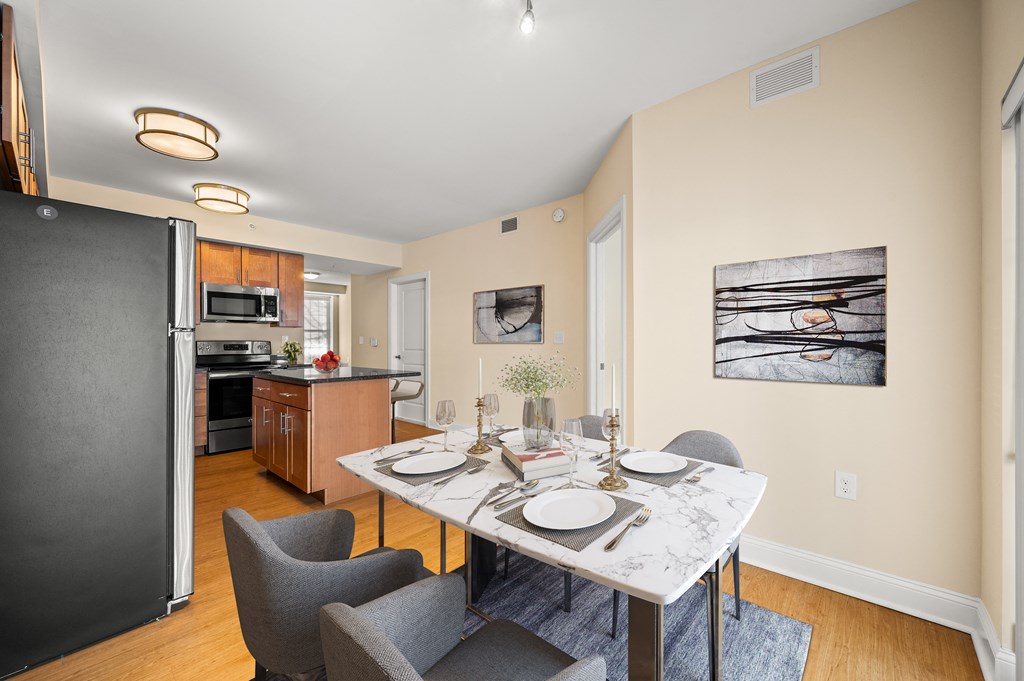 A dining room with a table set for two.