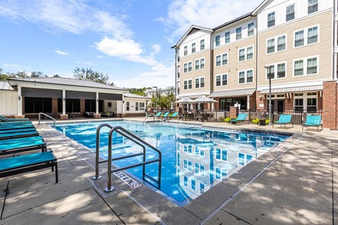 Resort-style pool and lounge area at The Flats at Tioga Town Center apartments in Newberry, FL.