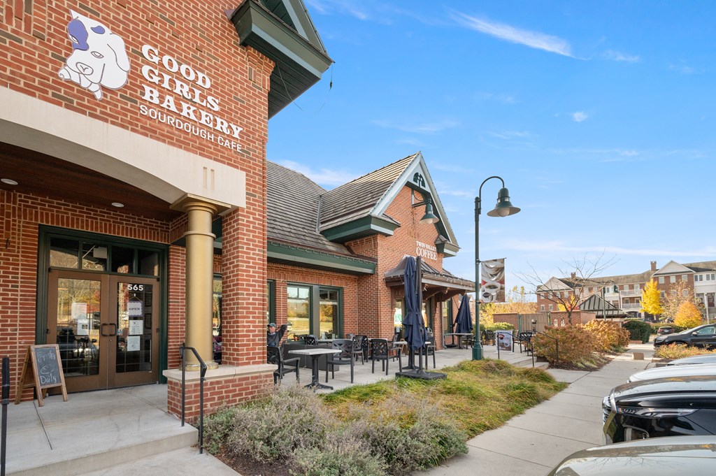 A brick building with a sign that says Good Girls Bake Sourdough Cafe.