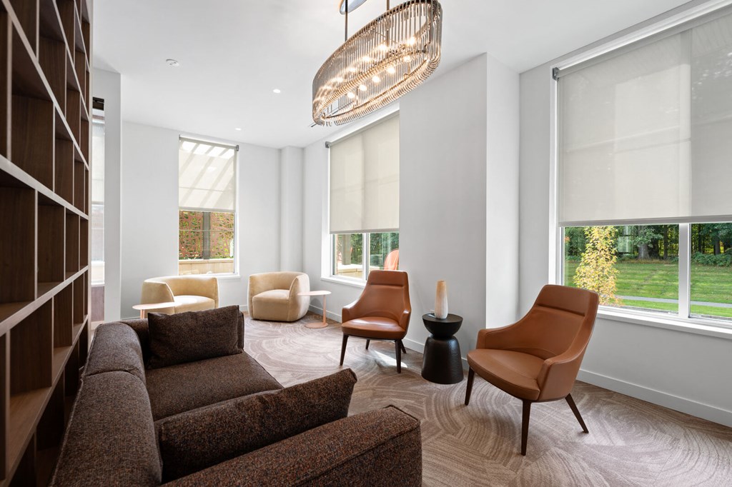 Inviting living room with a cozy couch, comfortable chairs, and large window offering natural light at Hamilton at Eagleview, Exton, PA