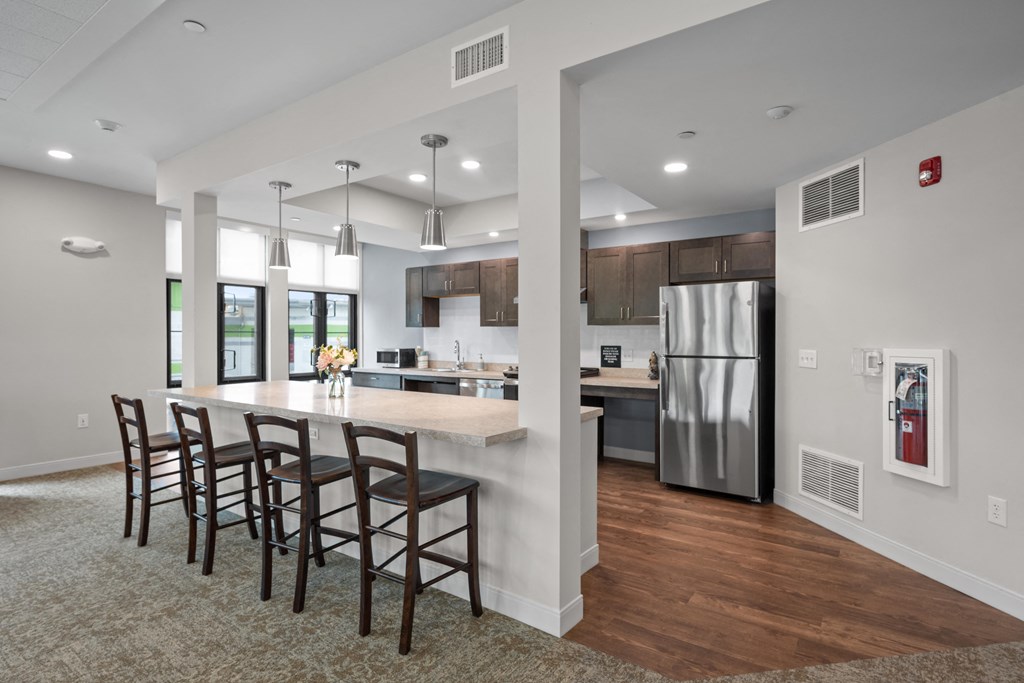 a kitchen with stainless steel appliances and a large island with chairs