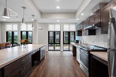 a large kitchen with an island and stainless steel appliances