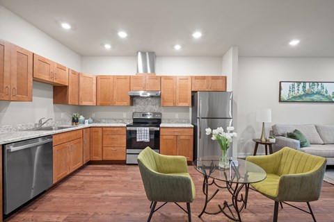 a kitchen with wooden cabinets and a table with chairs