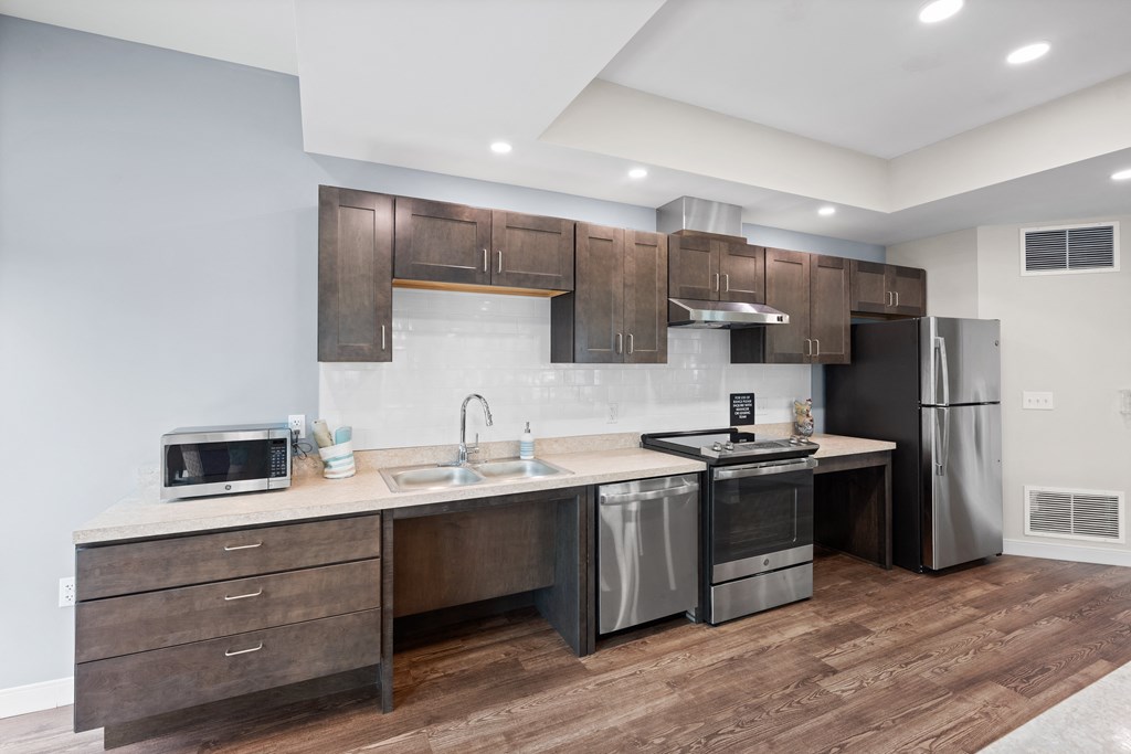 a kitchen with stainless steel appliances and wooden cabinets