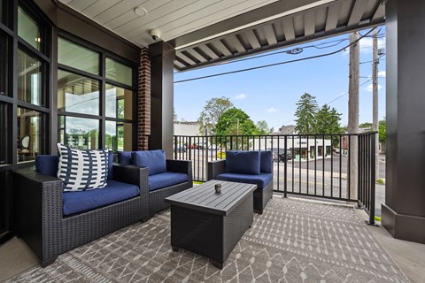 a patio with couches and a coffee table on a balcony