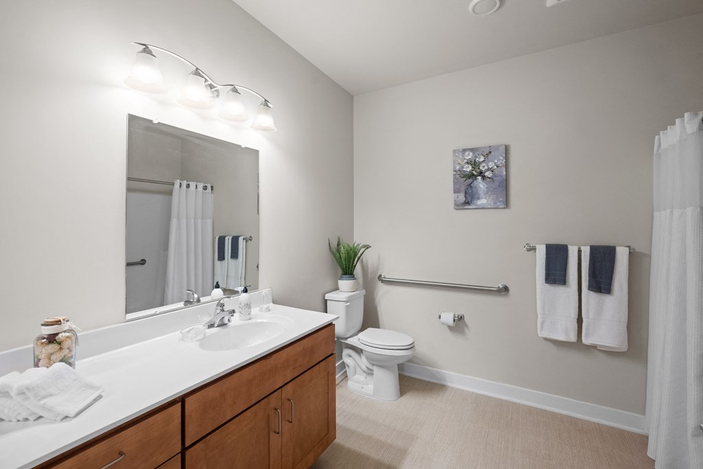 a bathroom with a large mirror and a sink and a toilet