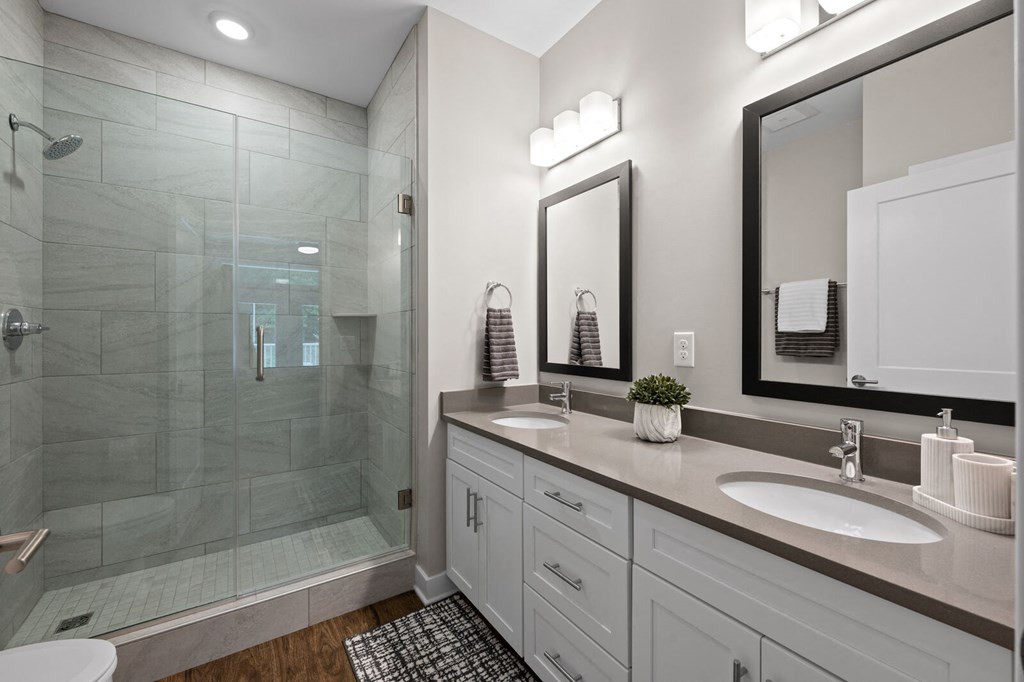 Spacious bathroom with double sinks and a glass shower at Hamilton at Eagleview, Exton, PA