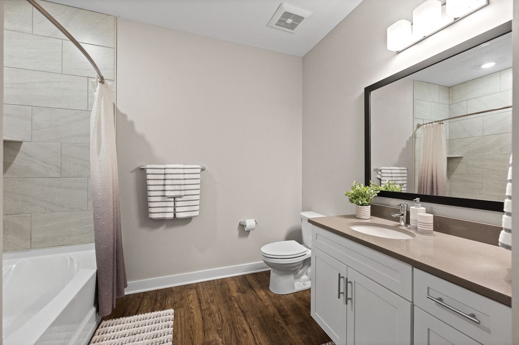 Modern bathroom featuring a large mirror, a shower, and a toilet at Hamilton at Eagleview, Exton, PA 19341