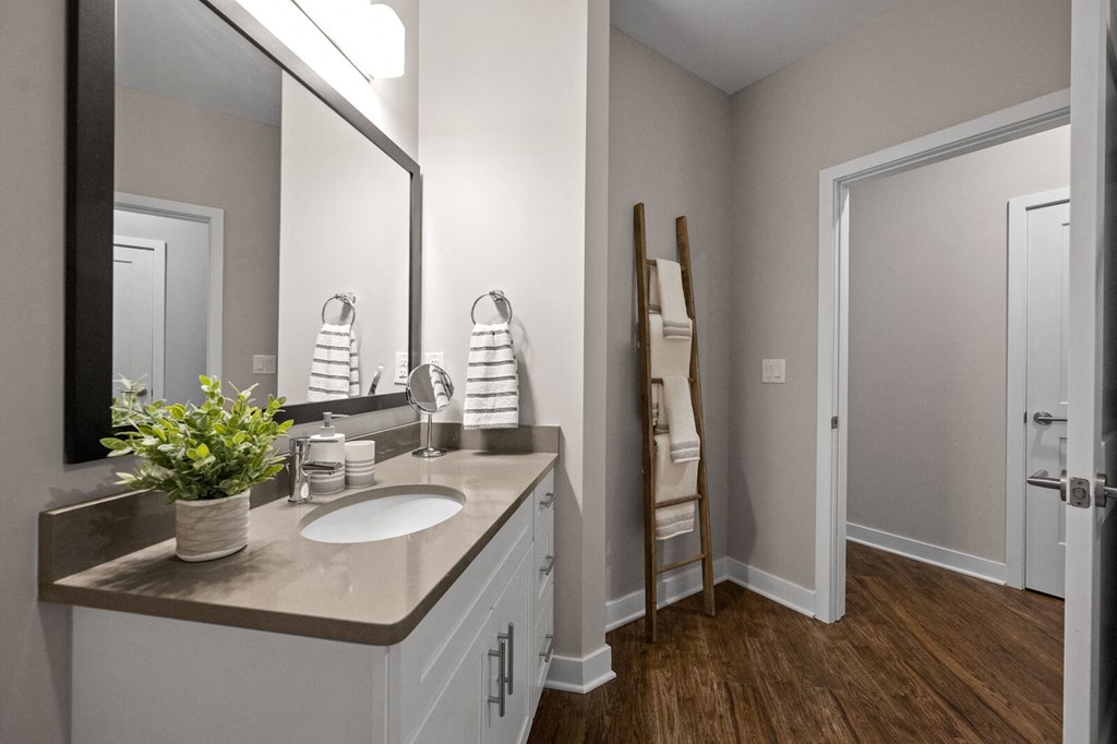 Modern bathroom with a sink, mirror, and doorway at Hamilton at Eagleview, Exton, PA 19341