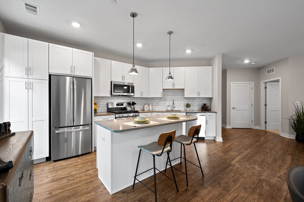 Spacious kitchen with white cabinetry, stainless steel appliances, and modern finishes at Hamilton at Eagleview in Exton, PA