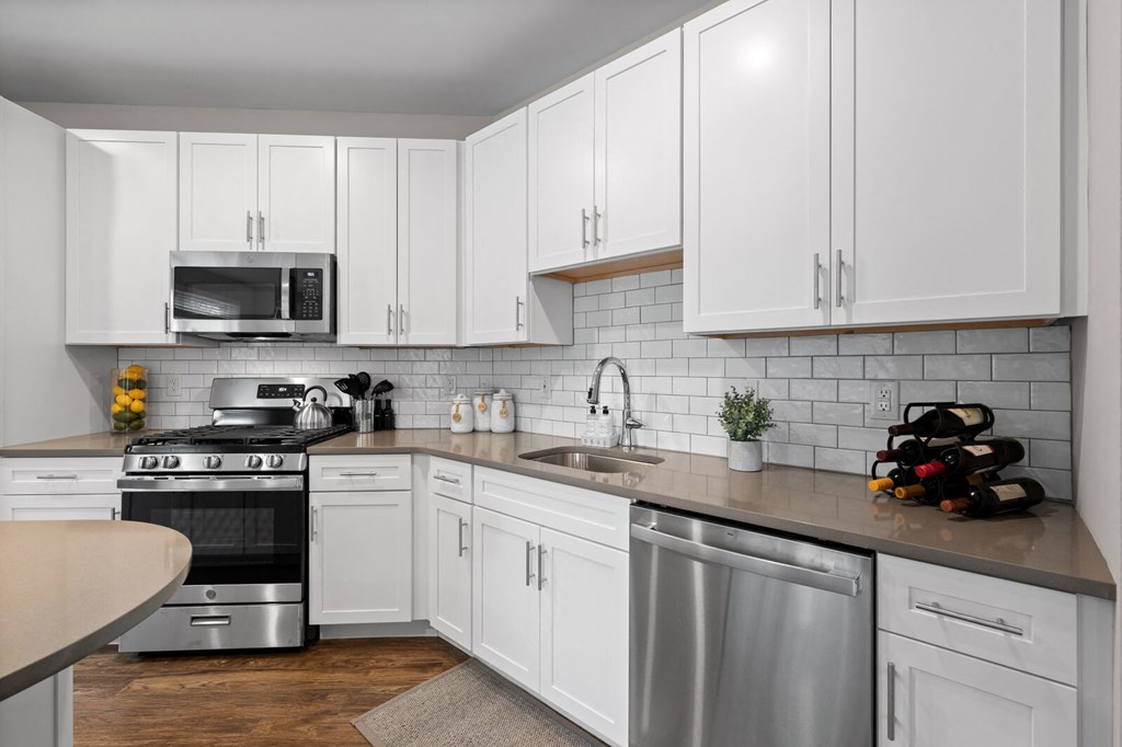 Contemporary kitchen with white cabinetry, stainless steel appliances, and sleek finishes at Hamilton at Eagleview in Exton, PA